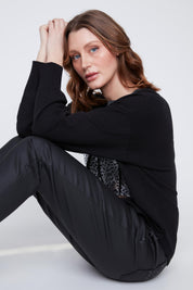 Chandail Cyc en tricot fin noir, avec un col brillant et un imprimé de carrés léopard argent et bronze ornés de deux cœurs.