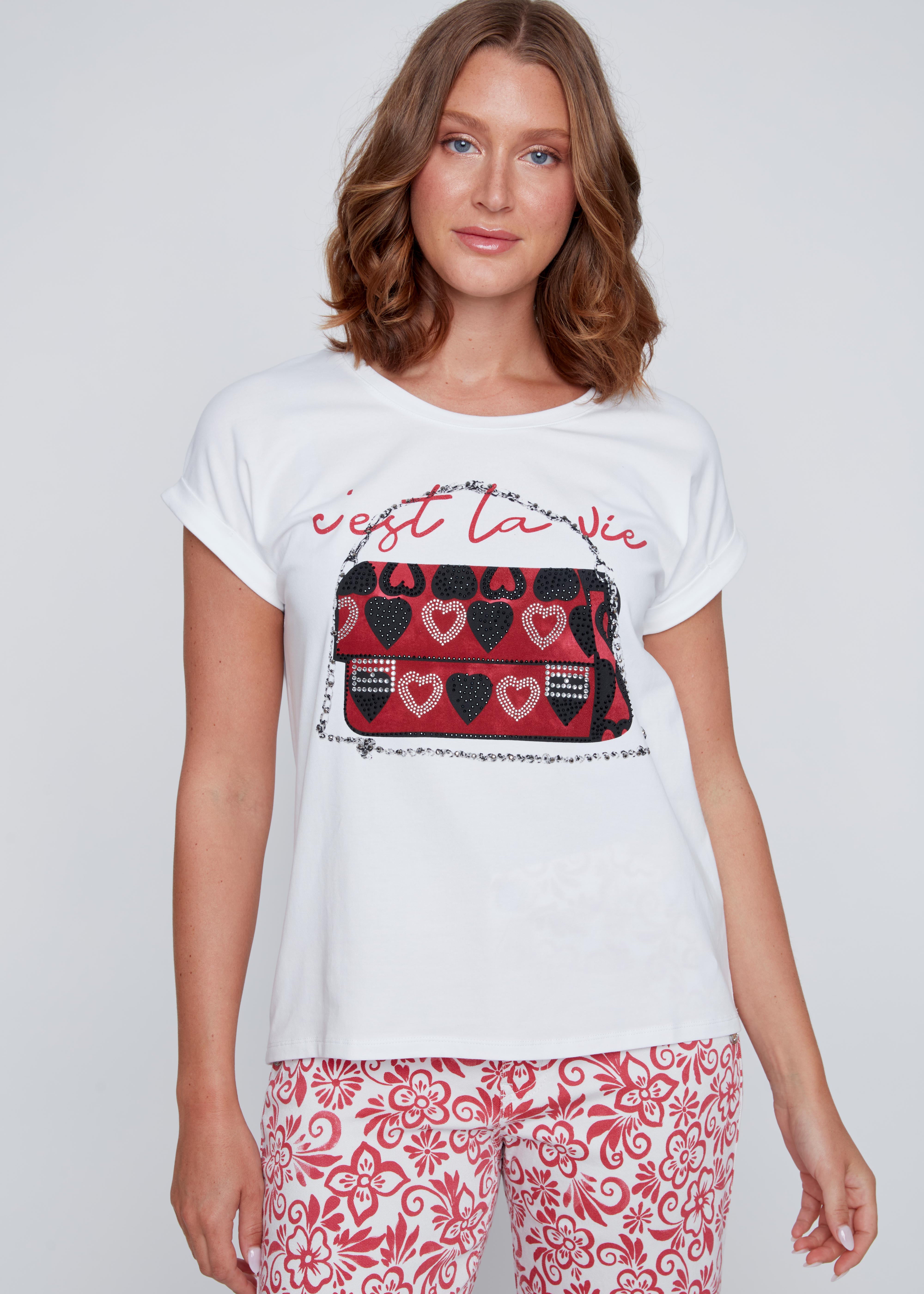 T-shirt blanc à col rond avec inscription « c’est la vie », imprimé sac à main avec cœurs, strass et petites pierres, détails noirs ou argentés.