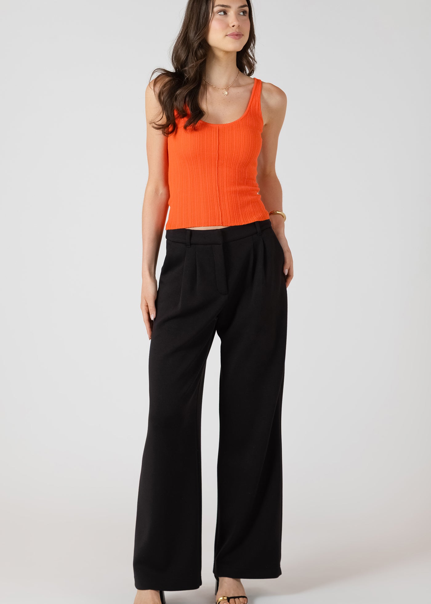 Pantalon large à plis en tissu confort, couleurs perle et noir, tissu extensible en rayonne, polyester et spandex, style fluide et élégant.
