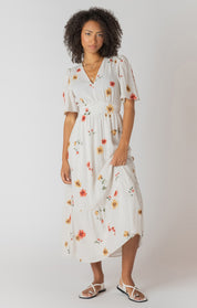 Robe longue à imprimé floral multicolore, col en V et dos nu, tissu souple en polyester et élasthanne, style féminin et léger.