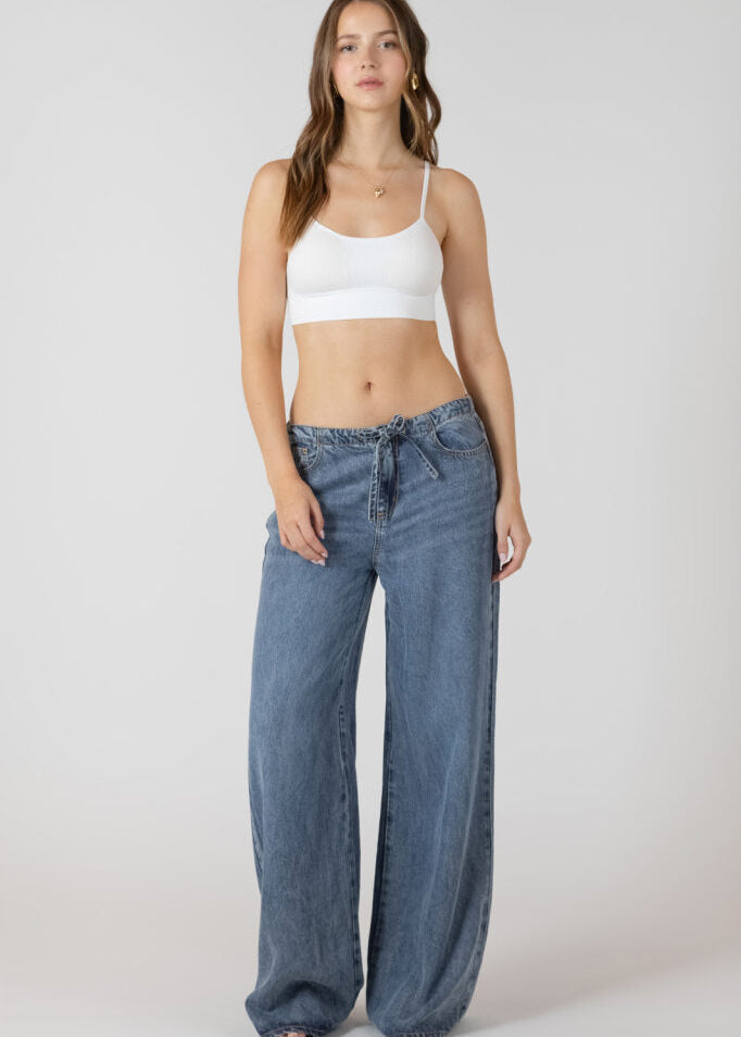 Bralette sans couture avec pads amovibles, bretelles ajustables, tissu extensible en nylon et spandex, couleurs beige et blanc, style confortable et épuré.