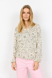 blouse en Lyocell doux. Col V, manches longues et imprimé à pois floraux délicat. Parfaite pour un look élégant et confortable.